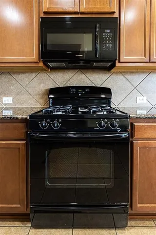 a stove top oven sitting inside of a kitchen