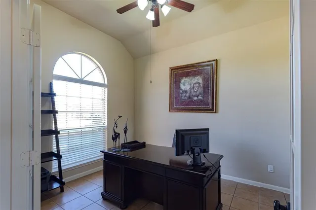 a view of a workspace with furniture and a window