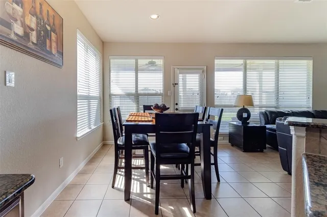 a view of a dining room with furniture and window