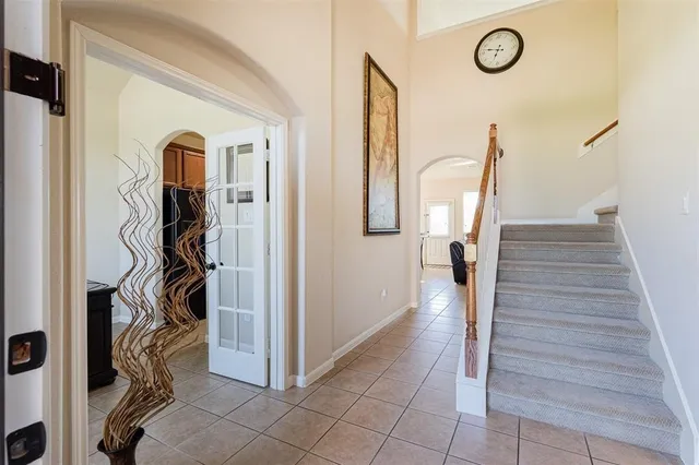 a view of a hallway with wooden floor and stairs