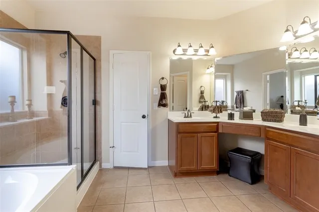 a large kitchen with a large counter top sink and refrigerator