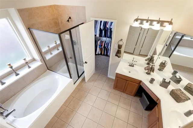 a spacious bathroom with a sink a mirror and shower