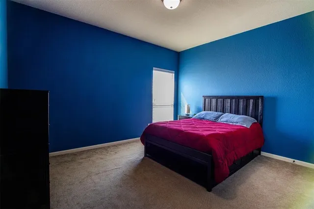 a spacious bedroom with a bed and a table in it