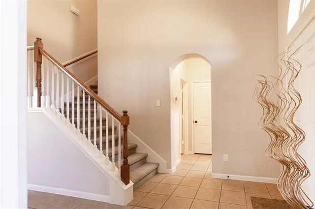 a view of a hallway with entryway wooden floor and front door
