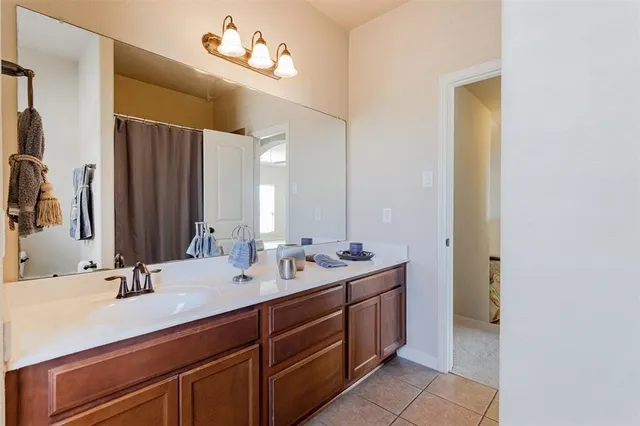 a bathroom with a double vanity sink a mirror and a bathtub