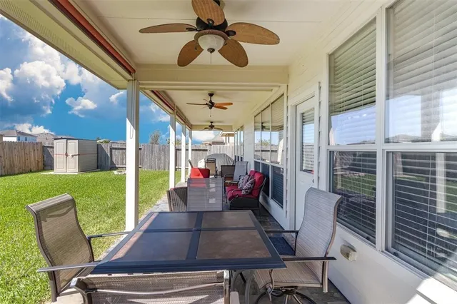 a view of a patio with table and chairs potted plants with wooden floor