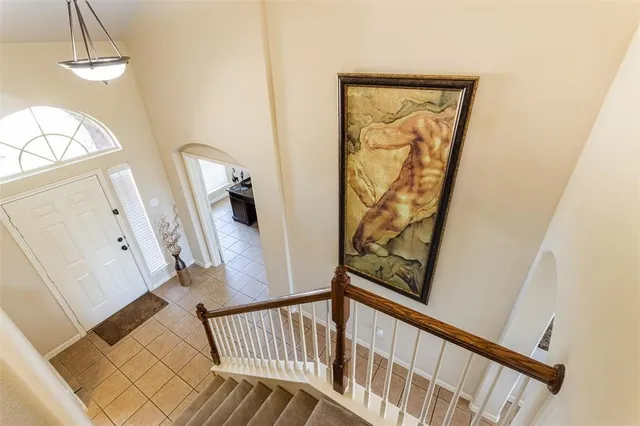 a view of a hallway with wooden floor and stairs