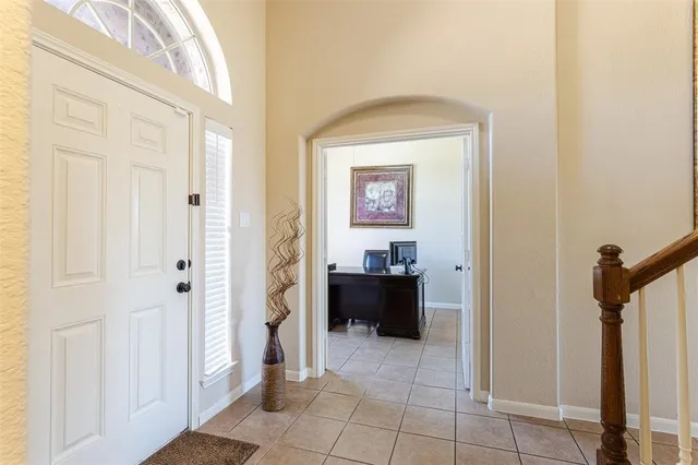 a view of a hallway to a livingroom with furniture