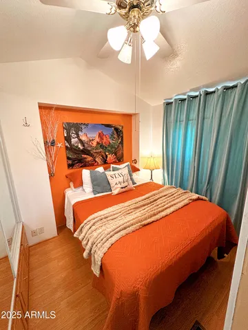 a bedroom with a bed and a chandelier