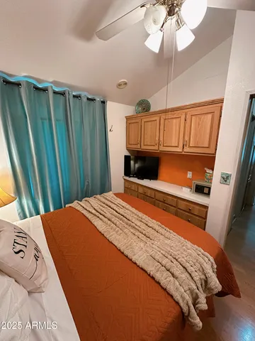 a bedroom with two beds and a chandelier