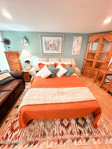 a bedroom with furniture and wooden floor