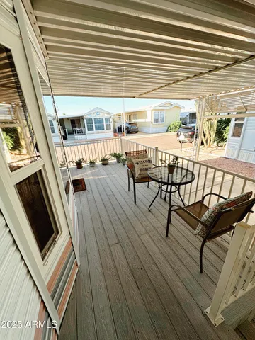 a view of a chairs and table in the balcony
