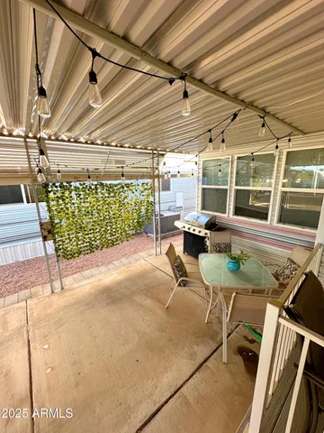 a view of a patio with table and chairs