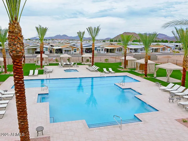 a view of a swimming pool with lawn chairs
