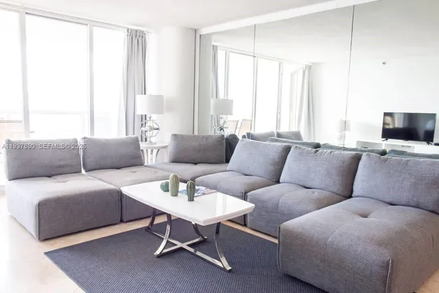 a living room with furniture and a large window