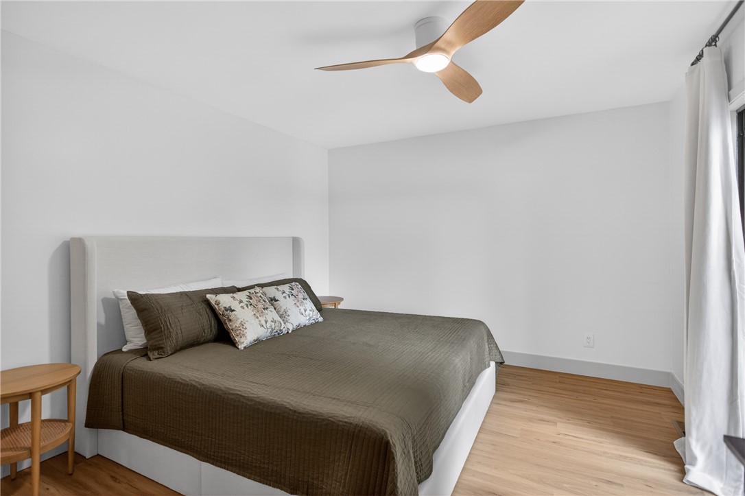 304 Lakeside Drive Seneca, SC 29672 - Photo 37 of 49 Hardwood floors and a sleek ceiling fan define this comfortable bedroom retreat.