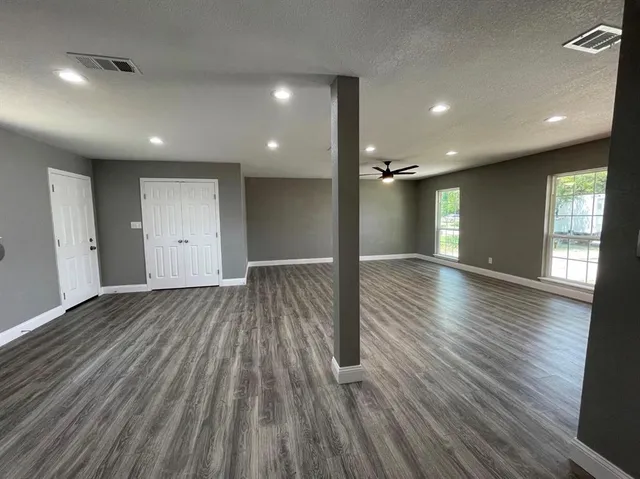 a kitchen with granite countertop a stove a sink and a refrigerator