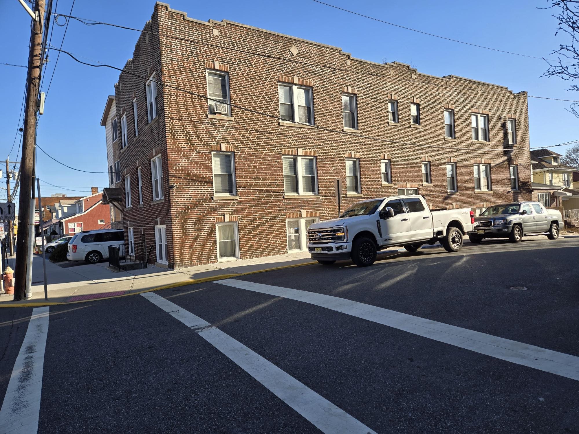a couple of cars parked in front of a building