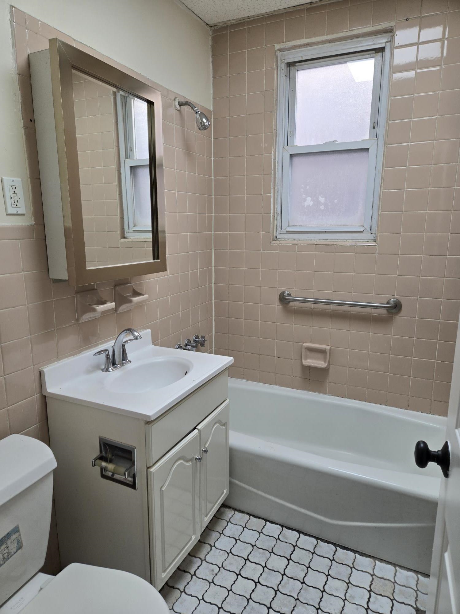 436 Anderson Avenue, Unit 4 Cliffside Park, NJ 07010 - Photo 6 of 7 a bathroom with a sink toilet vanity and tub