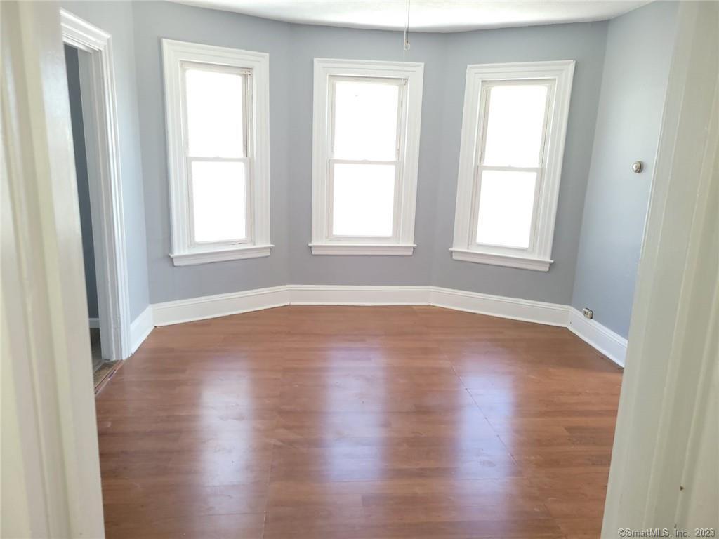 30 King Street, Unit 2 Hartford, CT 06114 - Photo 1 of 1 an empty room with wooden floor and windows