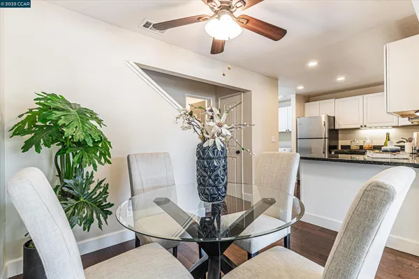 a view of a dining room with furniture and chandelier