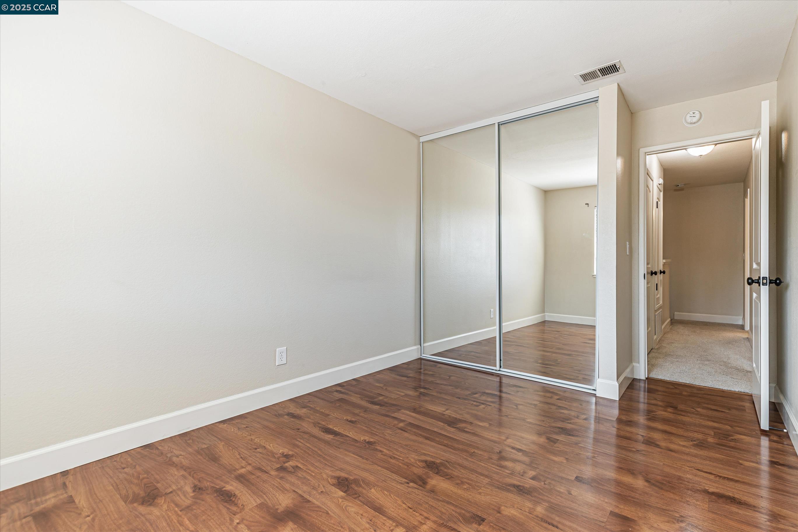 5055 Valley Crest Drive, Unit 196 Concord, CA 94521 - Photo 18 of 36 a view of an empty room with wooden floor and a bathroom