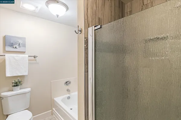 a bathroom with a toilet a sink and a shower