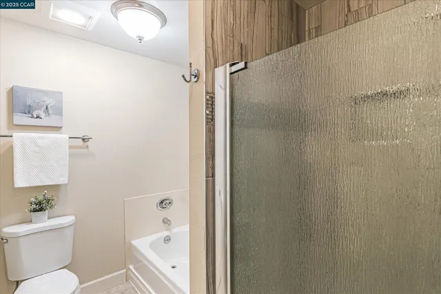 a bathroom with a toilet a sink and a shower