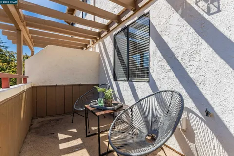 a balcony with table and chairs