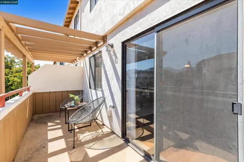 a view of a chairs and table in the balcony