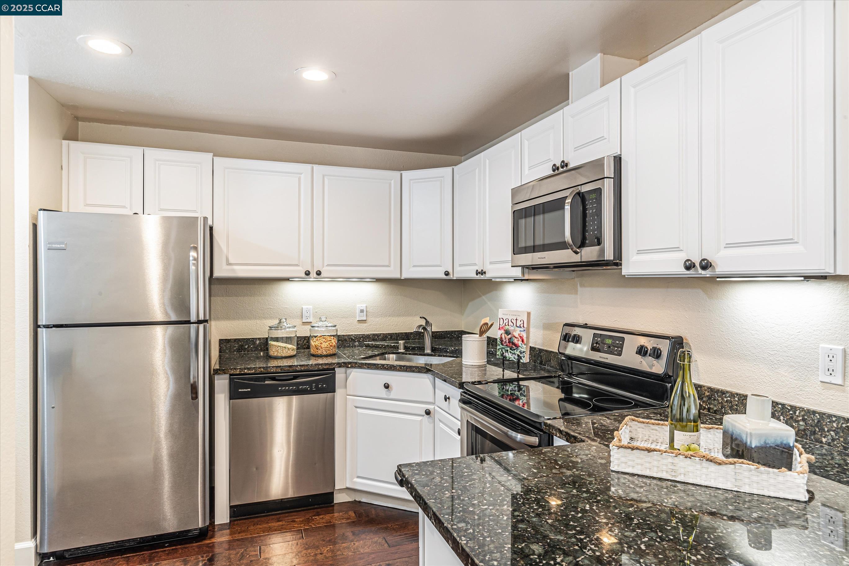 5055 Valley Crest Drive, Unit 196 Concord, CA 94521 - Photo 9 of 36 a kitchen with stainless steel appliances granite countertop a refrigerator stove microwave and sink