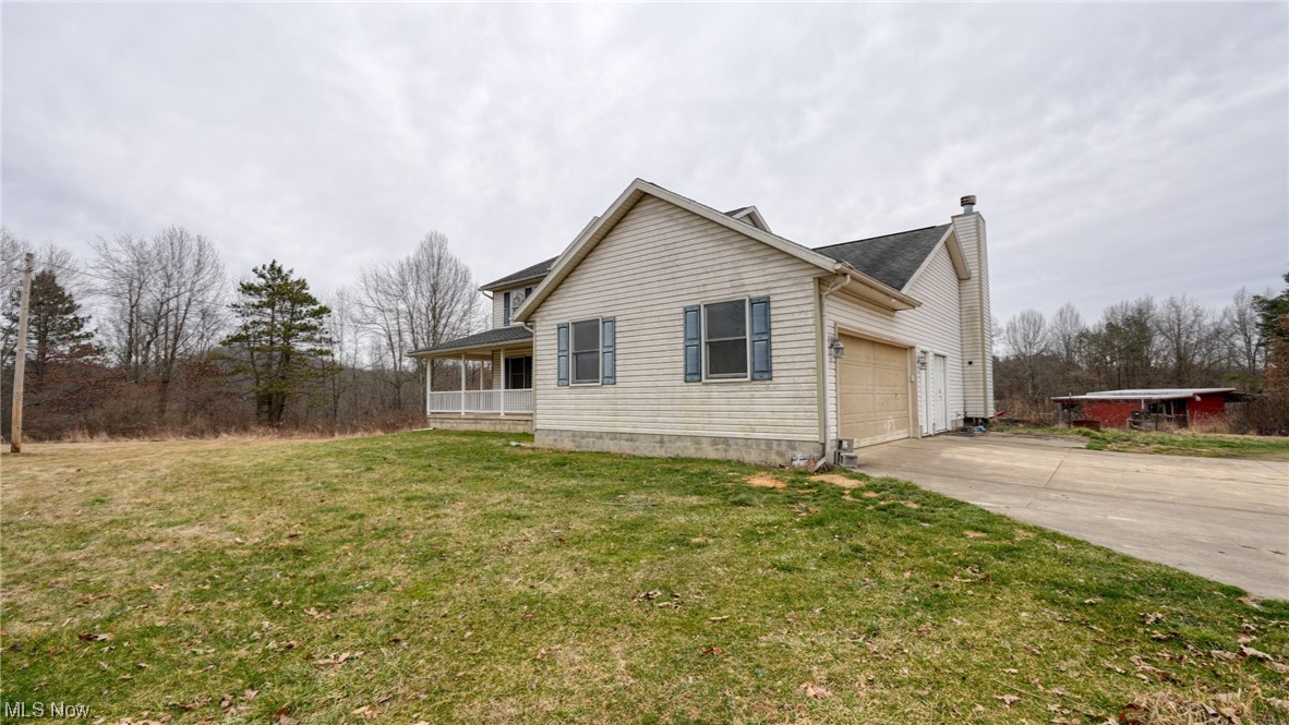 3752 Holmes Road Cambridge, OH 43725 - Photo 3 of 50 View of property exterior featuring a lawn