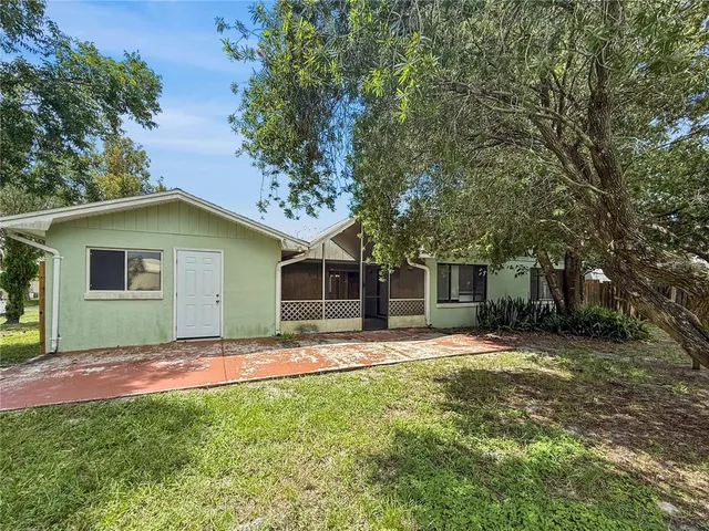 a backyard of a house with table and chairs
