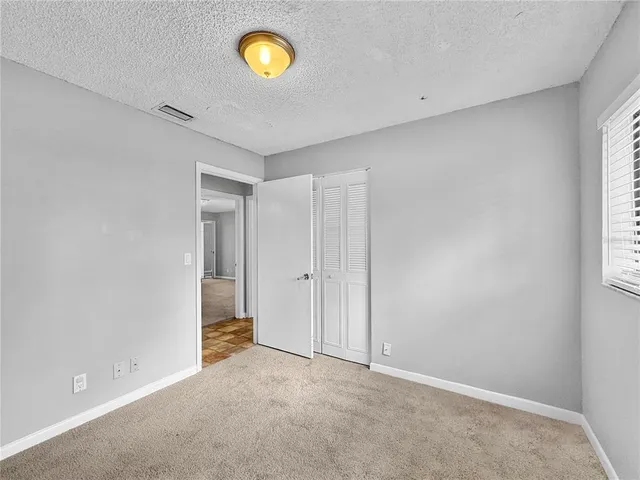 a view of an empty room and a window