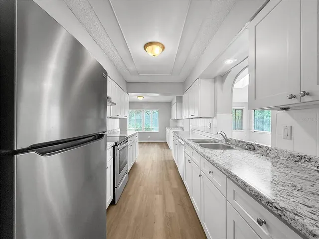 a kitchen with a sink and refrigerator