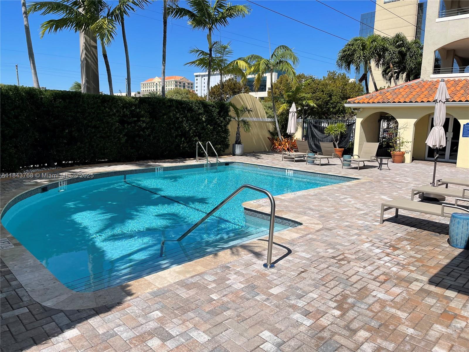 2351 Douglas Road, Unit 1208 Miami, FL 33145 - Photo 13 of 18 a view of a backyard with plants and swimming pool