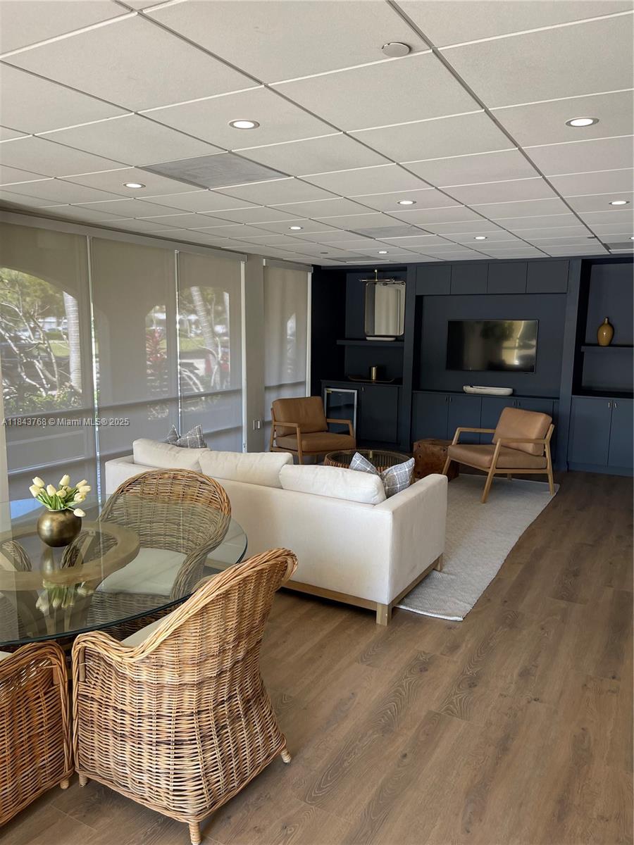 2351 Douglas Road, Unit 1208 Miami, FL 33145 - Photo 14 of 18 a living room with furniture and a flat screen tv