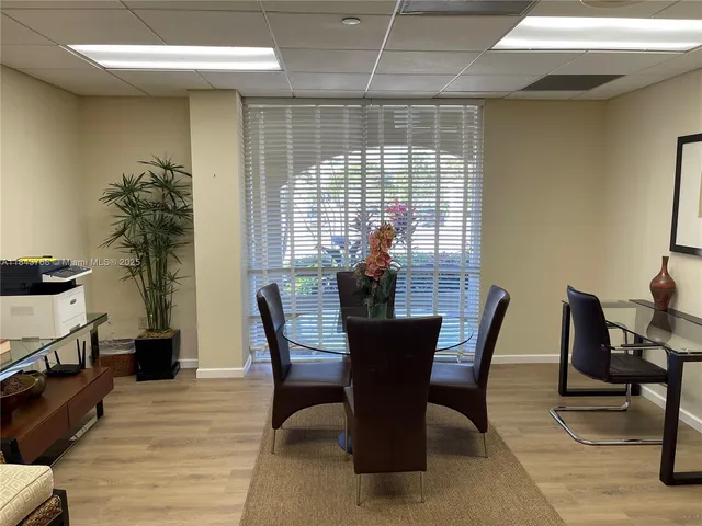 a view of a patio with table and chairs near a yard