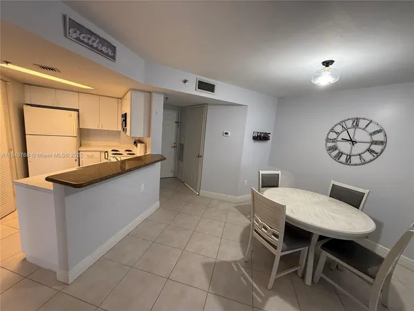 a kitchen with stainless steel appliances granite countertop a sink and a refrigerator