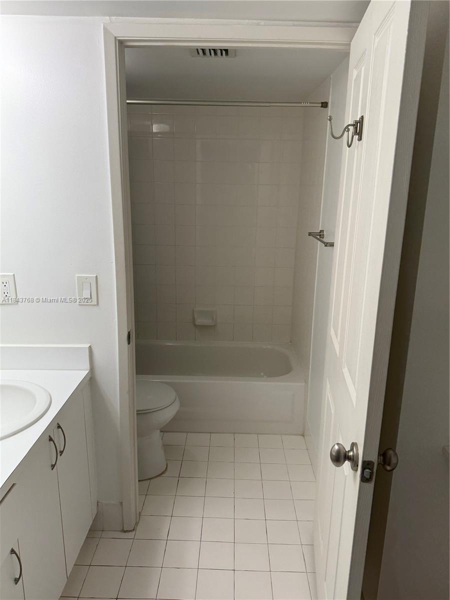 2351 Douglas Road, Unit 1208 Miami, FL 33145 - Photo 8 of 18 a bathroom with a granite countertop sink a toilet and shower