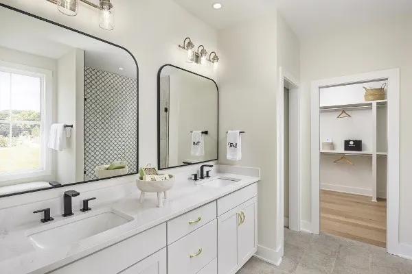 a bathroom with double vanity sinks and a mirror