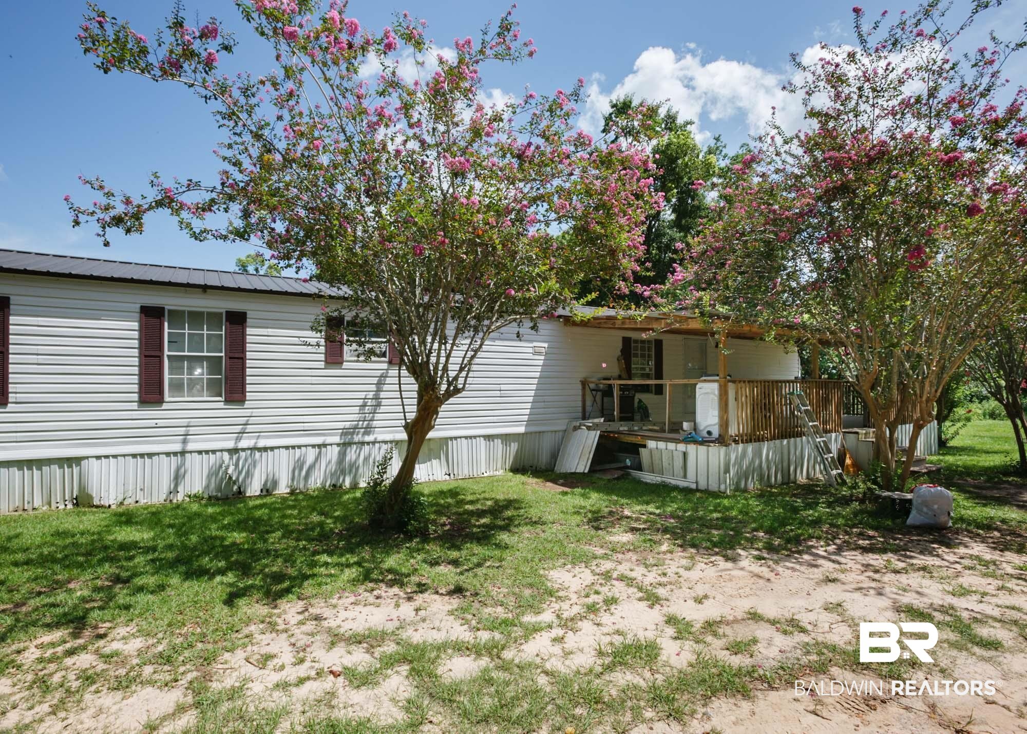 14005 County Road 49 Foley, AL 36535 - Photo 2 of 38 Back of house featuring a wooden deck and a lawn