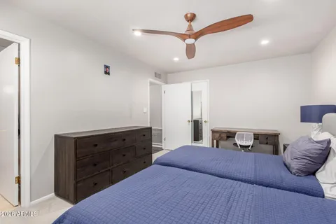 a bedroom with a large bed and a window
