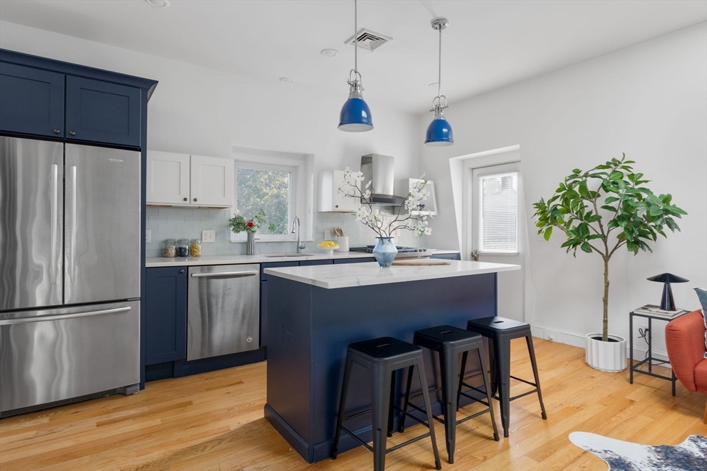 12 Grand View Avenue, Unit 3 Somerville, MA 02143 - Photo 1 of 10 a kitchen with kitchen island a counter space a sink appliances and cabinets