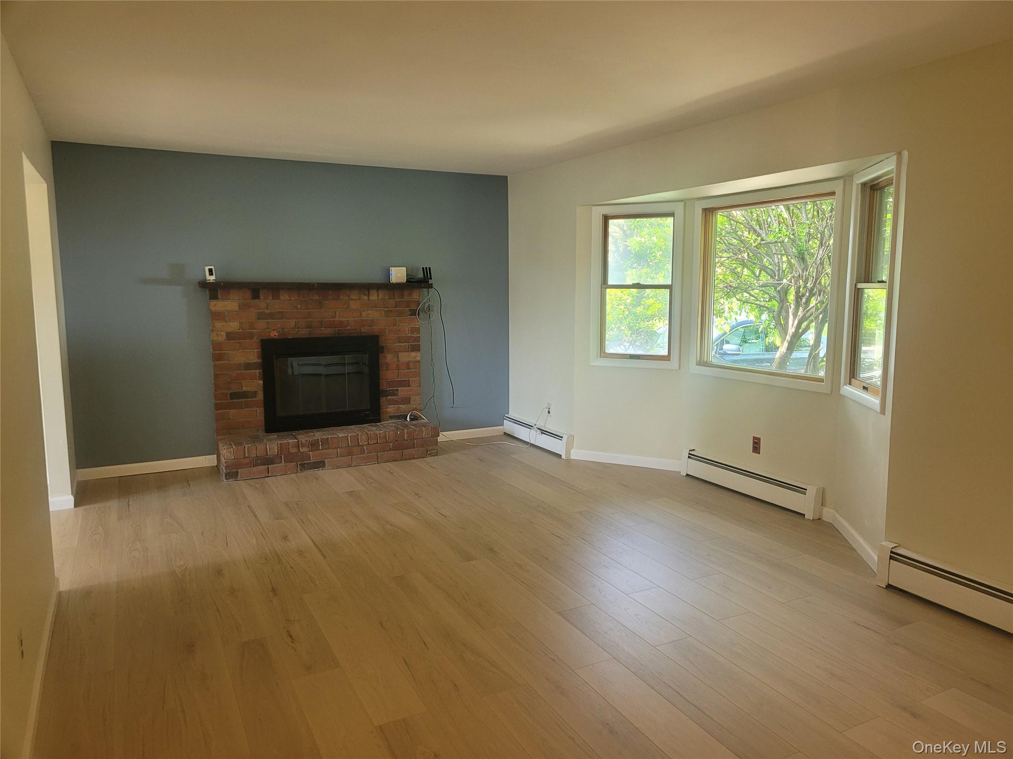 8 Cornell Road East Patchogue, NY 11772 - Photo 4 of 18 an empty room with a fireplace