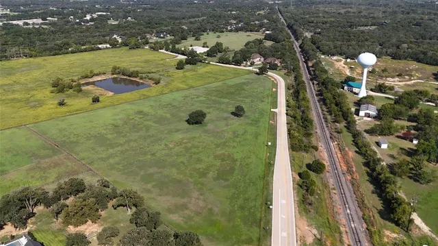 an aerial view of a residential houses with outdoor space