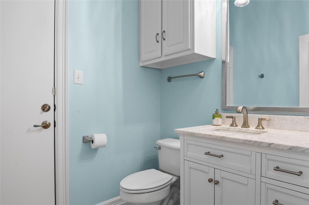 4451 Shiloh Road Midlothian, TX 76065 - Photo 27 of 39 Half bathroom located adjacent to the kitchen, garage entry, and laudry room. This bathroom has a door to the backyard, which is perfect for a future swimming pool.