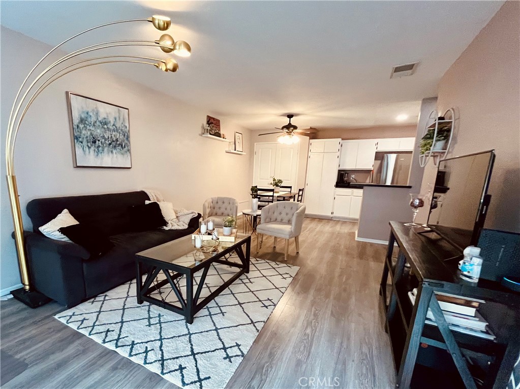 12635 Briarglen Loop, Unit K Stanton, CA 90680 - Photo 2 of 12 a living room with furniture and wooden floor