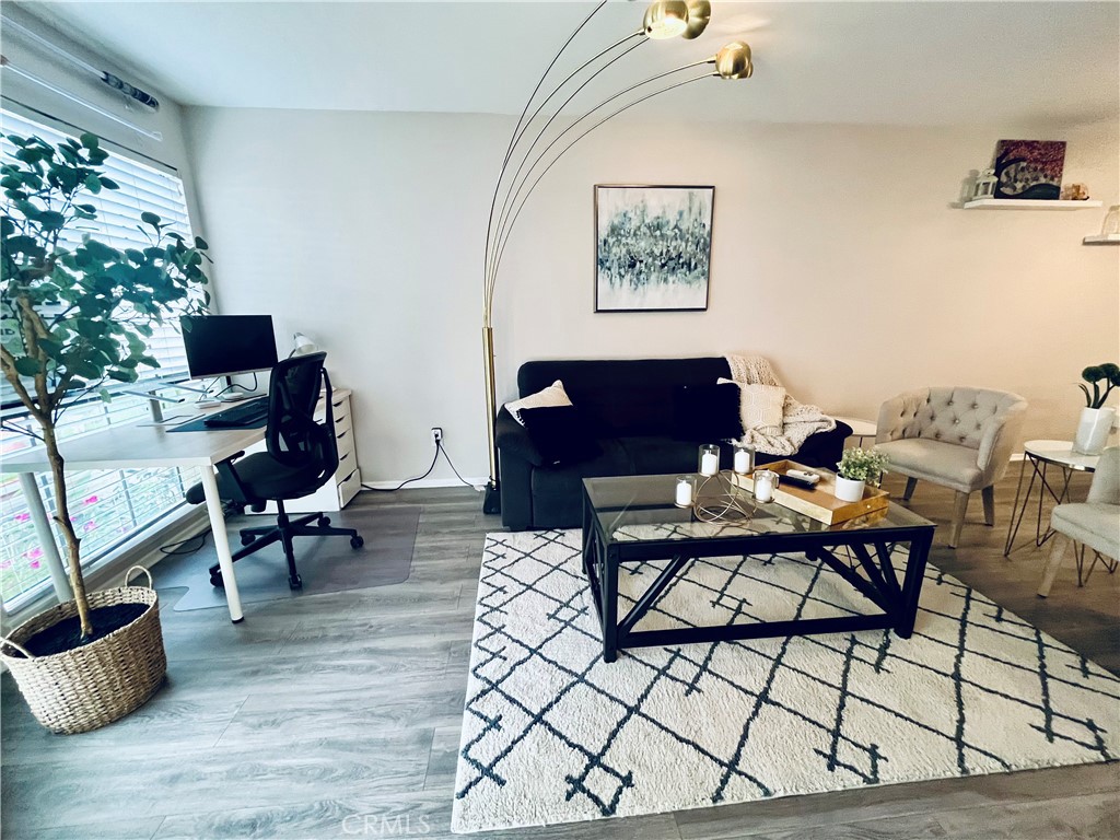 12635 Briarglen Loop, Unit K Stanton, CA 90680 - Photo 3 of 12 a workspace with furniture and a potted plant
