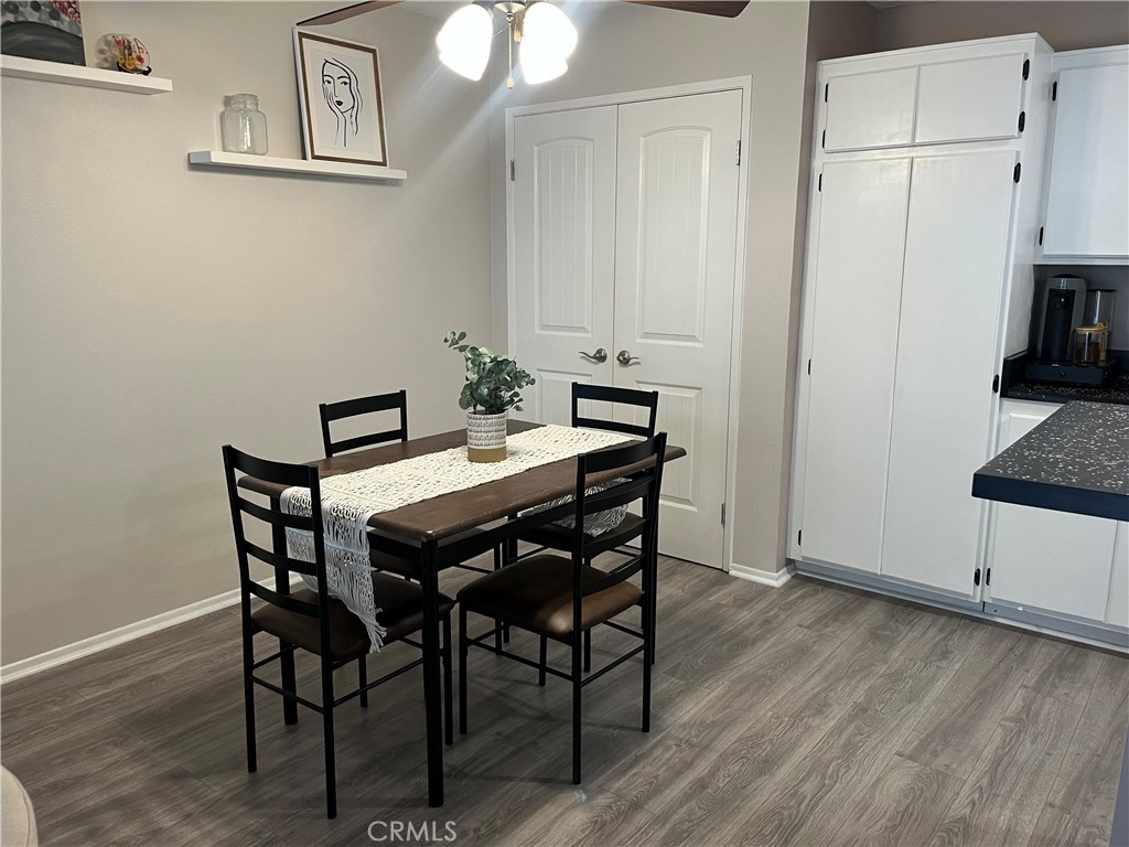 12635 Briarglen Loop, Unit K Stanton, CA 90680 - Photo 7 of 12 a view of a dining room with furniture and wooden floor